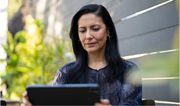 A woman looking at a digital tablet